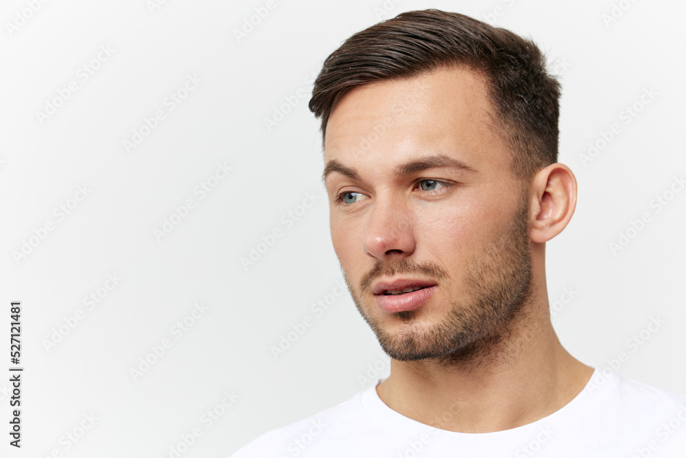 Closeup portrait. Flirted tanned handsome man in basic t-shirt raises eyebrow look aside posing isolated on white studio background. Copy space Banner Mockup. People emotions Lifestyle concept Closeup portrait. Flirted tanned handsome man in basic t-shirt raises eyebrow look aside posing isolated on white studio background. Copy space Banner Mockup. People emotions Lifestyle concept