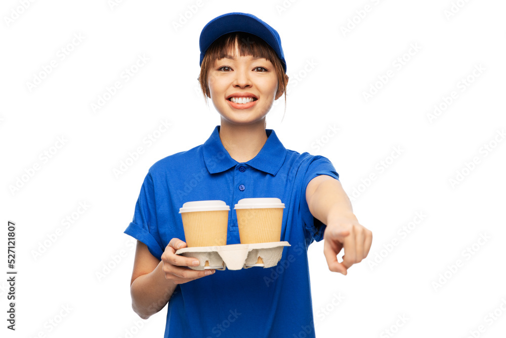 service and job concept - happy smiling delivery woman in blue uniform with takeaway hot drinks in disposable coffee cups over white background service and job concept - happy smiling delivery woman in blue uniform with takeaway hot drinks in disposable coffee cups over white background