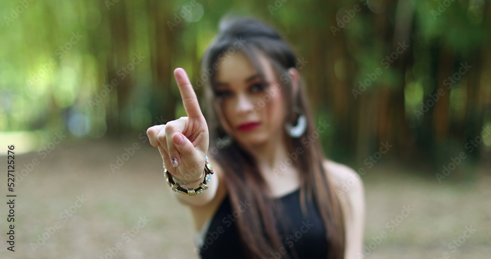 Woman annoyed making stop sign with hand, saying no, expressing defense or restriction Woman annoyed making stop sign with hand, saying no, expressing defense or restriction