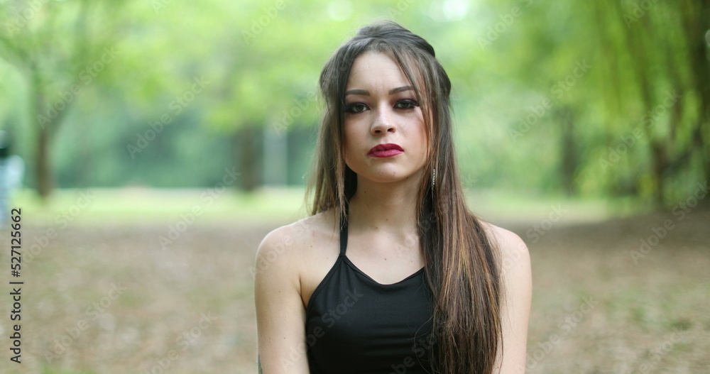 Unhappy young woman in 20s pointing finger to camera shaking head in disagreement
