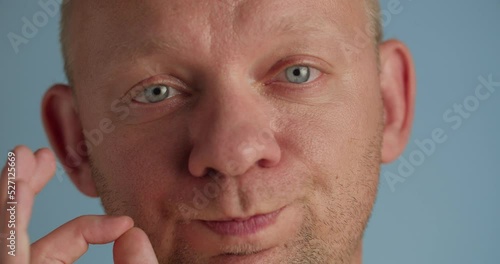 Guy makes silent gesture asking to stay quiet and keep secret