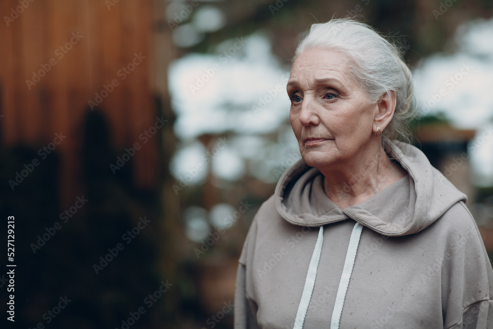 Portrait of mature gray haired elderly woman outdoor