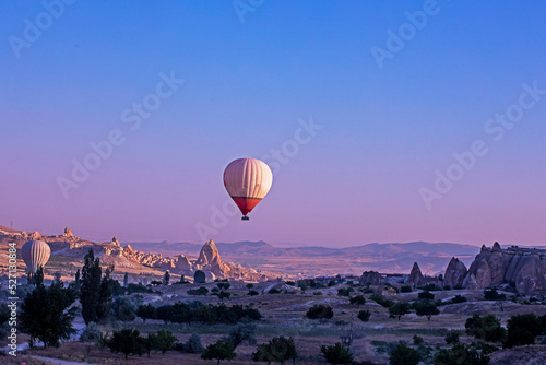 balloon over the hills in the mountains illuminated by the rays of the sun at dawn in the vicinity of Cappadocia View from above