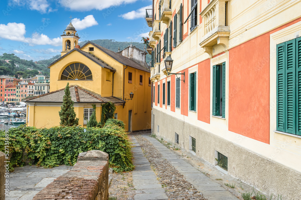 Narrow street between colorful buildings at the port of Santa Margherita, Ligure, Italy.