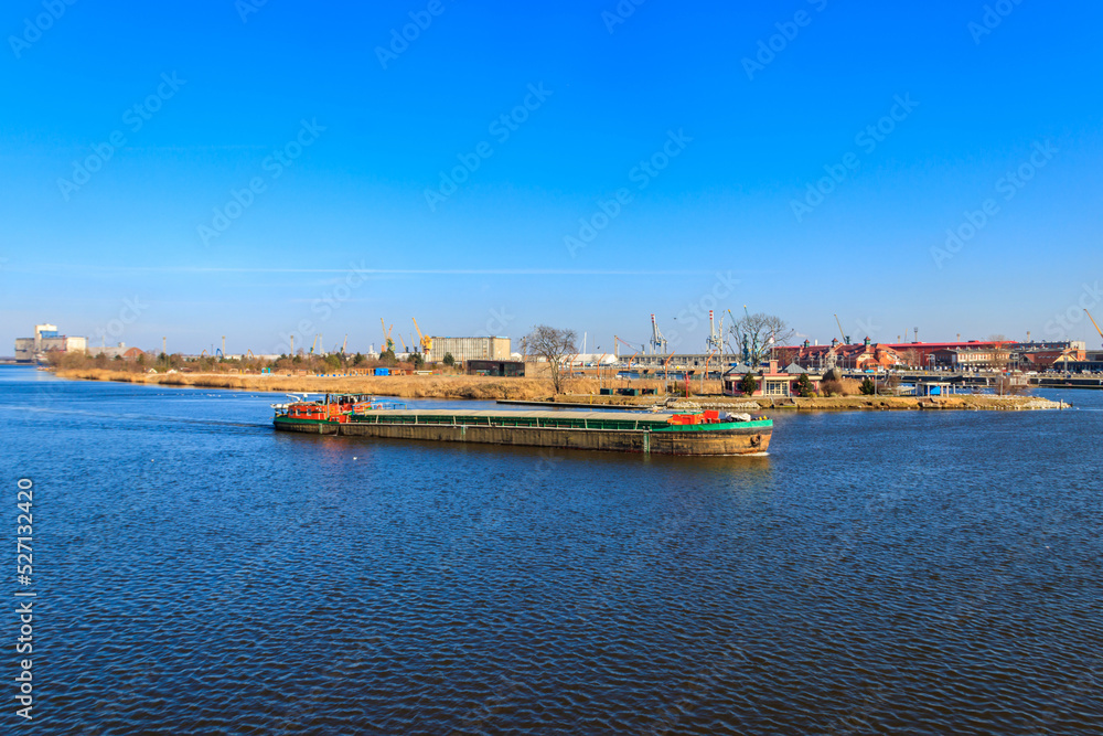 Barge sailing on the Oder river in Szczecin, Poland