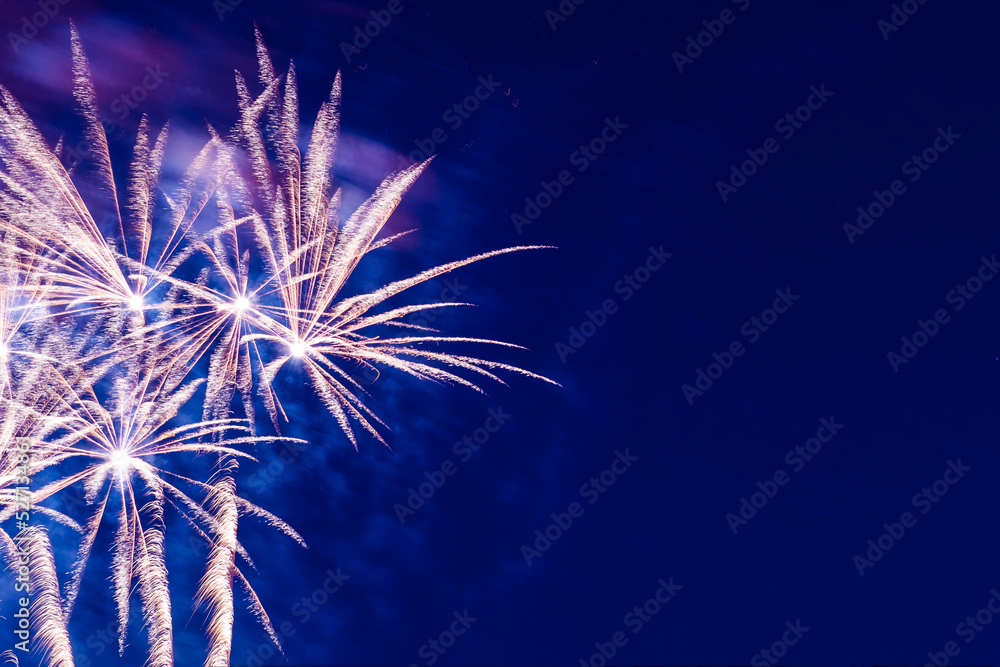 Bright, beautiful blue fireworks in the night sky.