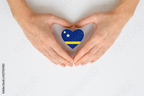 The national flag of Curacao in female hands.