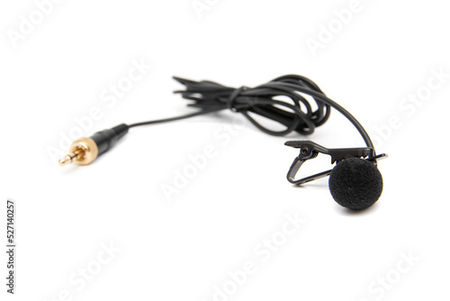 Lavalier microphone, isolated on white background. Selective focus. A lavalier microphone (also called a lavalier microphone, clip-on microphone, or personal microphone).