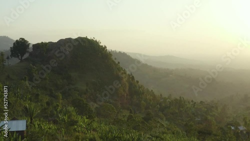 Aerial shot of a mountain surrounded by forest at sunset in Ethiopia