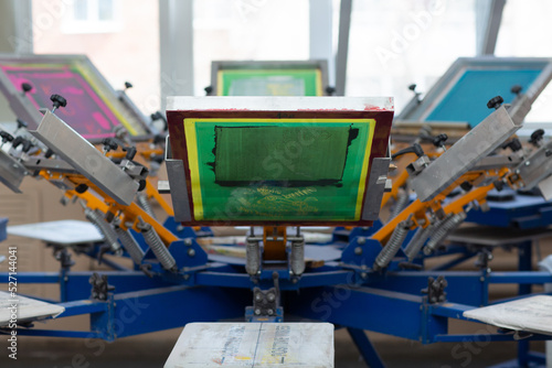 Carousel Frame, squeegee and plastisol color paint Serigraphy silk screen print process at clothes factory