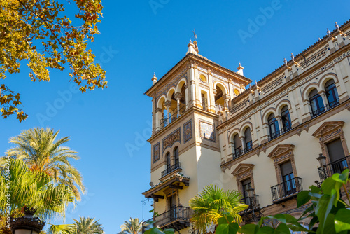 A historic building highlights Spanish architecture with Moorish influence in the Barrio Santa Cruz district of Seville, Spain. photo