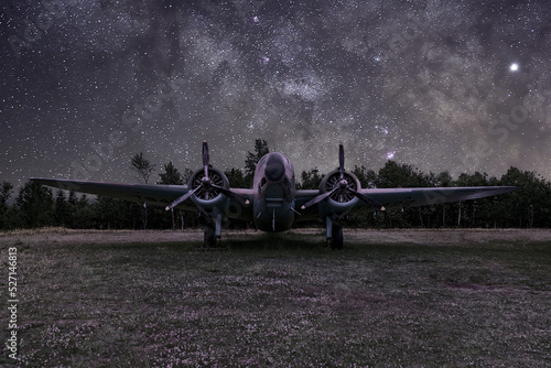 Photography A Lockheed Hudson Bomber rests in an open field under a starry sky at the North Atlantic Aviation Museum in Gander, Newfoundland