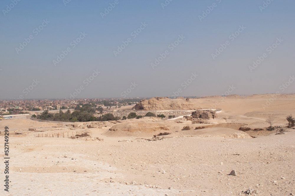 Sandy landscape in the desert in Cairo in front of the famous Egyptian pyramids