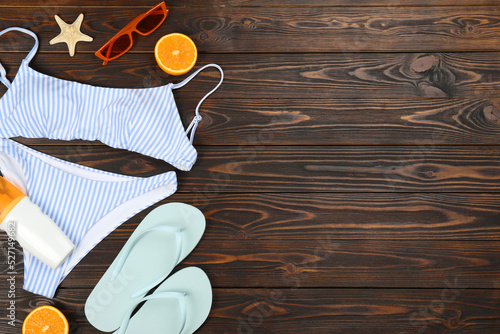 Flat lay composition with beach objects on wooden background, space for text