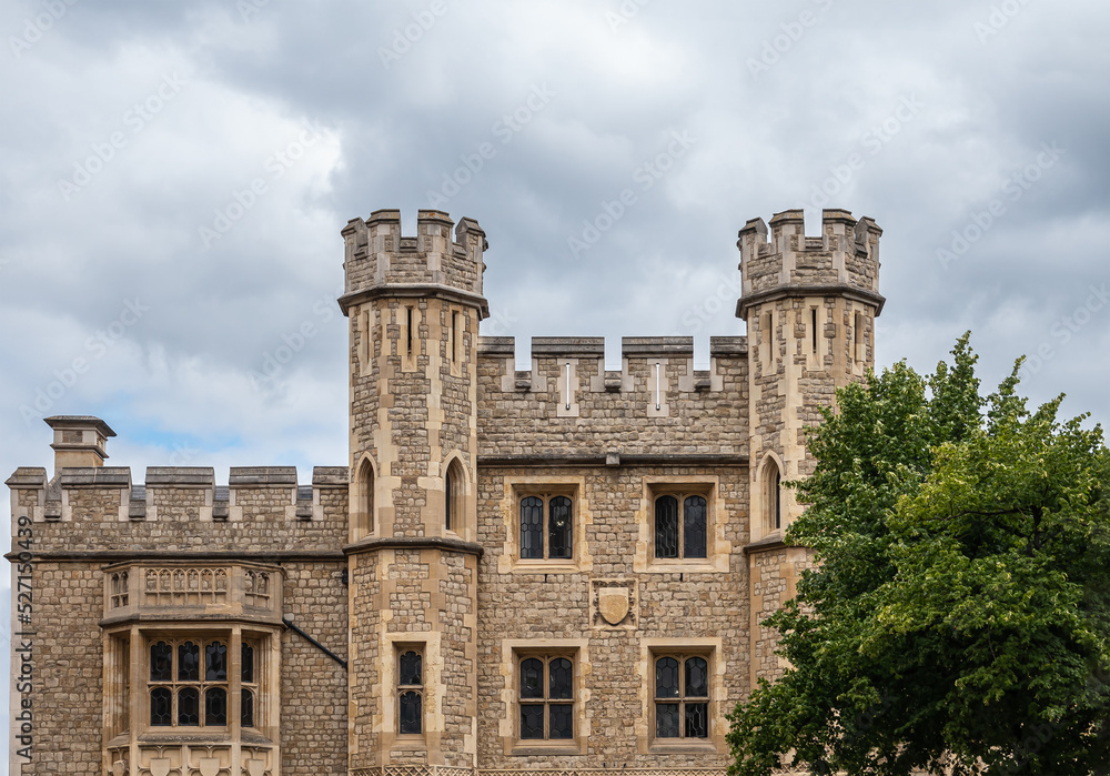 London, England, UK - July 6, 2022: Tower of London. Brown stone part of Fusilier Museum facade featuring coat of arms, lookout towers and windows.