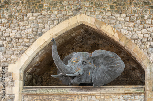 London, England, UK - July 6, 2022: Tower of London. Fake gray elephant head looks out of stables built under ramparts.