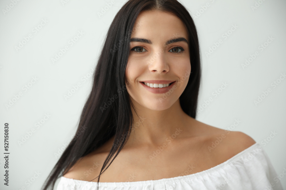 Beautiful young woman on light grey background Beautiful young woman on light grey background
