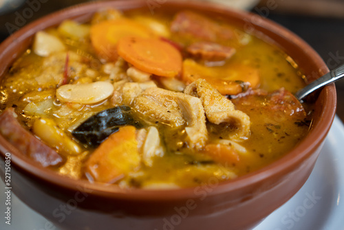 a close up of a pot with tripe and some vegetables.