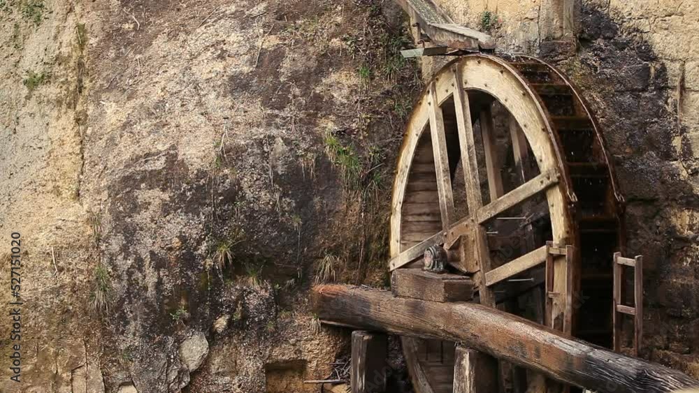 Looped rotation of the old mill's wheel on the waterfall. Veneto region, Italy Looped rotation of the old mill's wheel on the waterfall. Veneto region, Italy