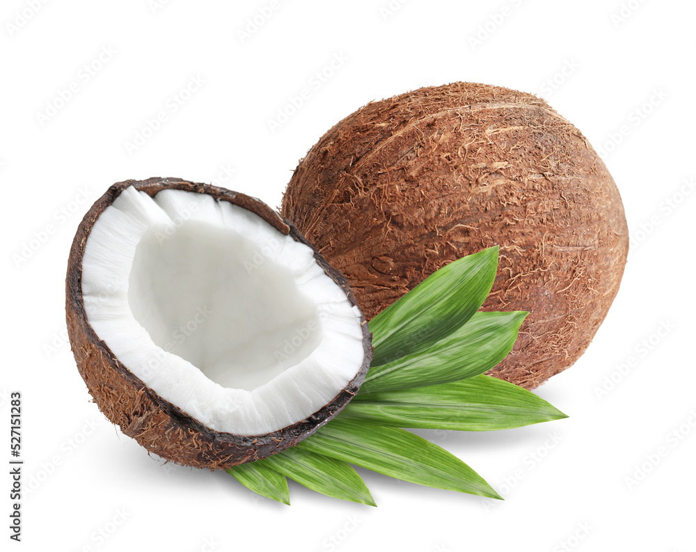 Tasty ripe coconuts and green leaves on white background Tasty ripe coconuts and green leaves on white background