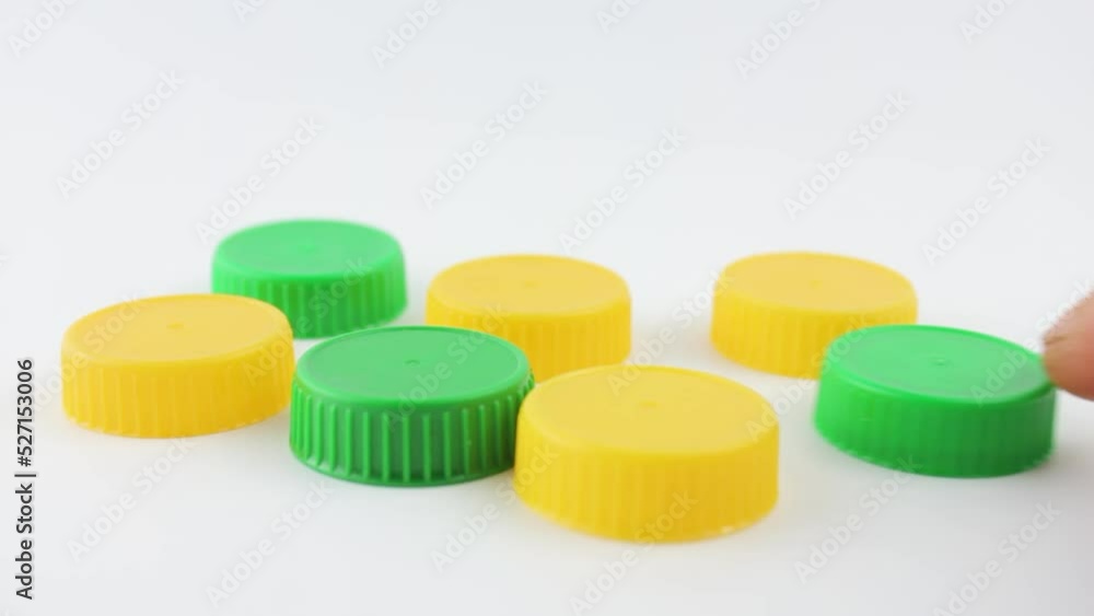 Plastic caps are green and yellow. Plastic caps from packaging, bottles. Plastic caps are green and yellow. Plastic caps from packaging, bottles.