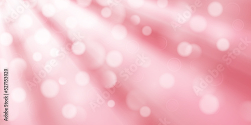 Abstract background in pink colors with diverging rays of light and small translucent circles with bokeh effect