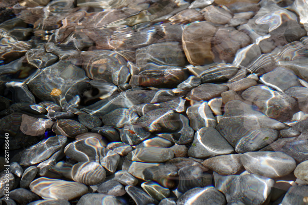 A bed of rocks and pebbles under clear creek water