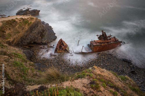 old stranded boat falling apart with the constant waves