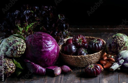 violet vegetables on the wooden background, purple artichoke, tomatoes, oniones, salad photo