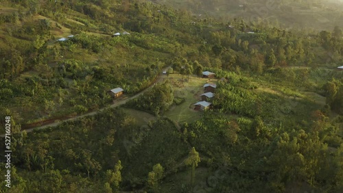 Aerial shot of a crowd in a small village surrounded by forest in Ethiopia