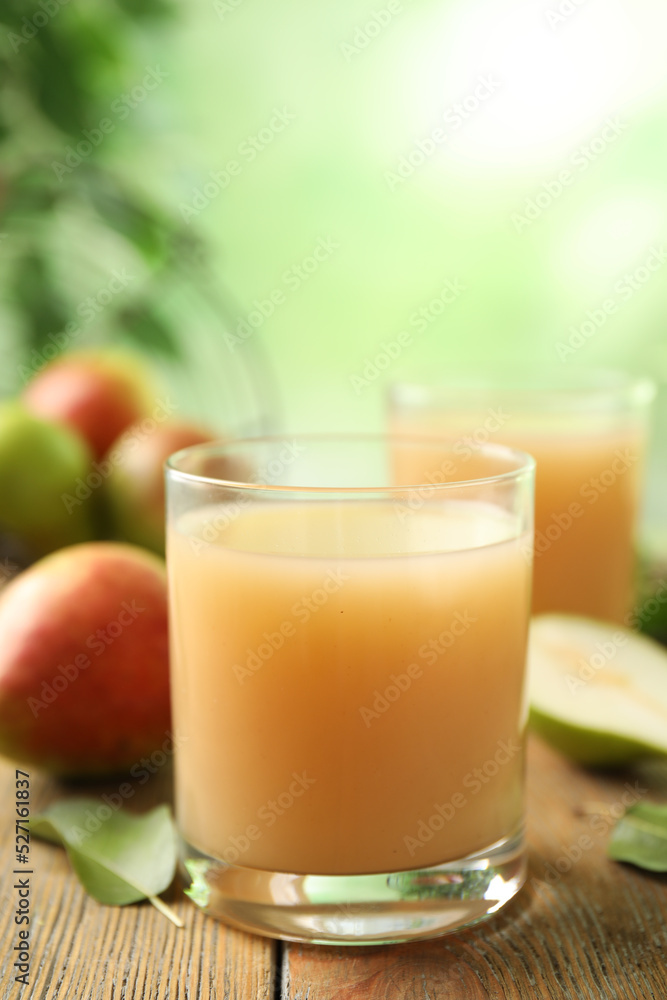 Fresh pear juice in glass on wooden table, closeup Fresh pear juice in glass on wooden table, closeup