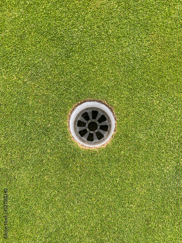 golf hole on golf green from arial point of view