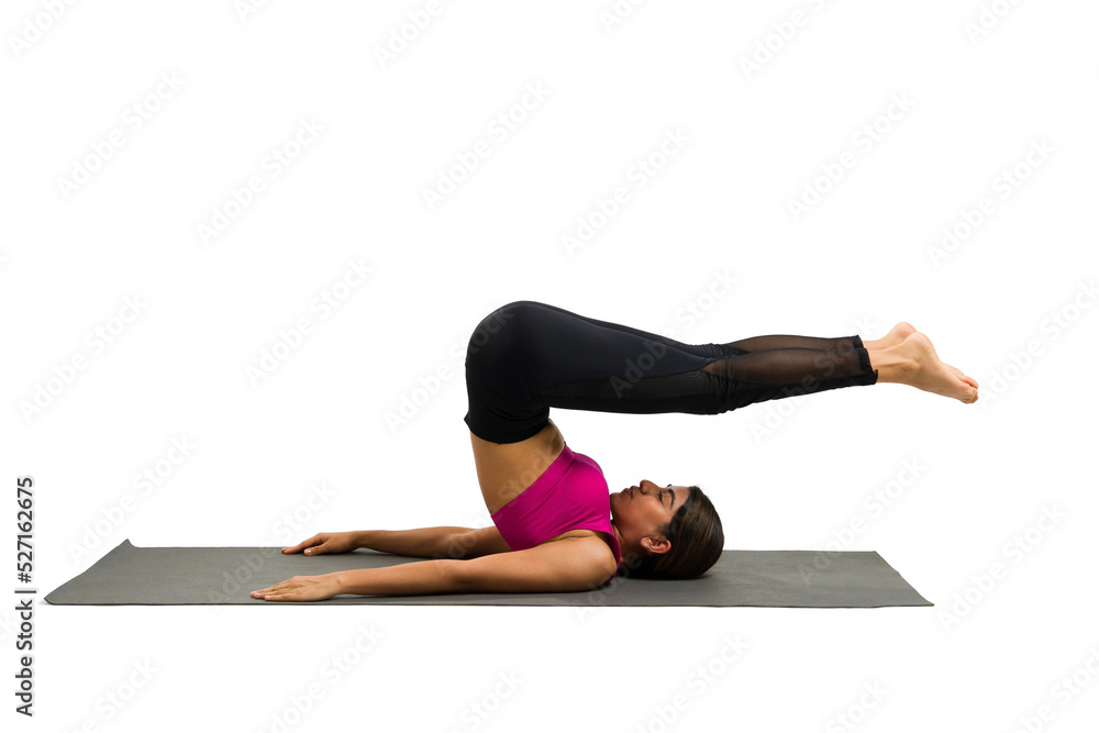 Flexible latin woman practicing a plow yoga pose Flexible latin woman practicing a plow yoga pose