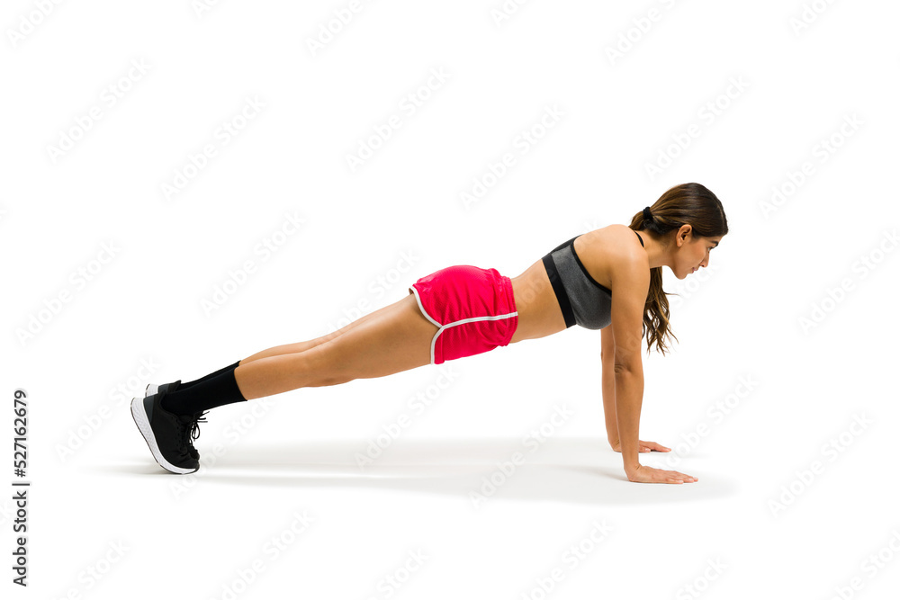 Profile of a sporty woman practicing a plank pose and working out Profile of a sporty woman practicing a plank pose and working out