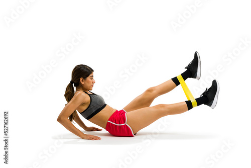Gorgeous fit woman doing abdominal crunches with a resistance band