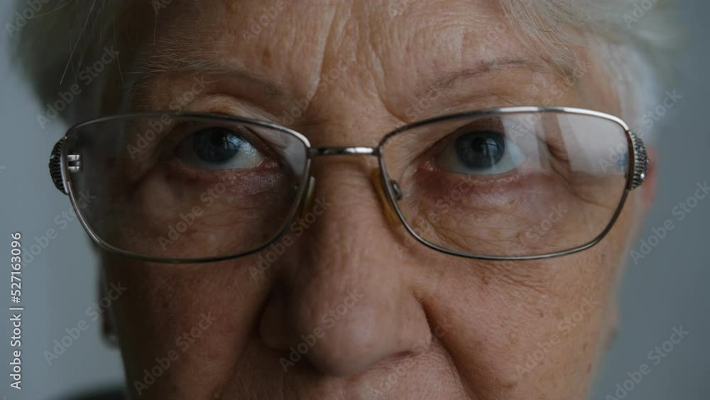Close up portrait of senior woman with gray eye's looking at the camera in glasses Close up portrait of senior woman with gray eye's looking at the camera in glasses
