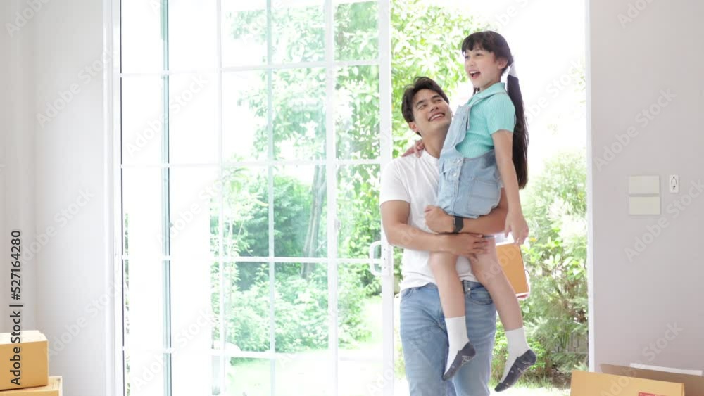 Happy asian family. Father, mother and daughter with cardboard excited to move in new house. They have big hug on moving day. Happy asian family. Father, mother and daughter with cardboard excited to move in new house. They have big hug on moving day.