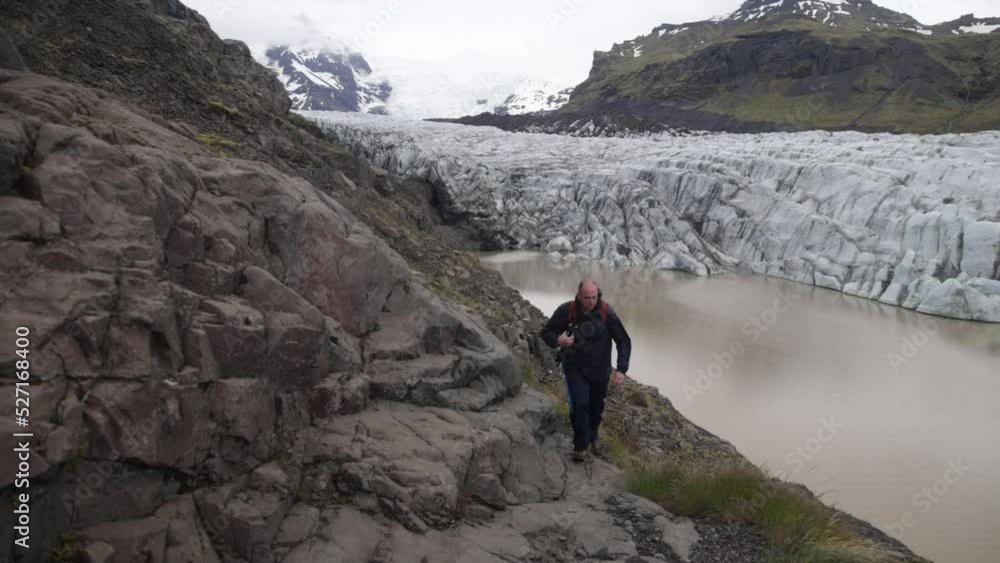 Iceland glacier with gimbal video moving forward with man walking past. Iceland glacier with gimbal video moving forward with man walking past.