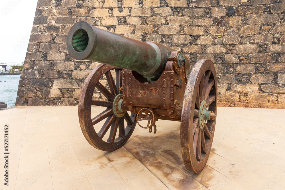 Antique Plasencia bronze cannon (210mm) in front of the Castle of San Gabriel. Lanzarote. Canary Islands. Spain. Antique Plasencia bronze cannon (210mm) in front of the Castle of San Gabriel. Lanzarote. Canary Islands. Spain.