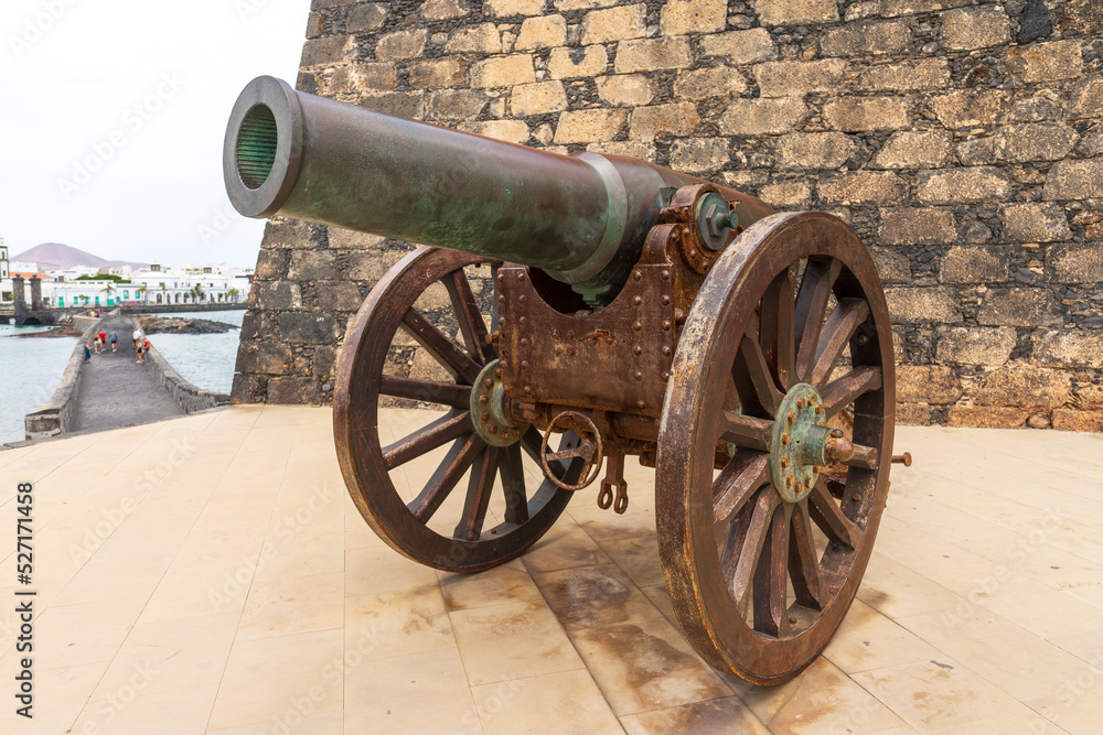 Antique Plasencia bronze cannon (210mm) in front of the Castle of San Gabriel. Lanzarote. Canary Islands. Spain. Antique Plasencia bronze cannon (210mm) in front of the Castle of San Gabriel. Lanzarote. Canary Islands. Spain.