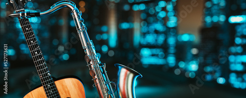 Photography Saxophone and guitar against the backdrop of the city at night.