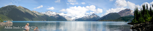 Wallpaper Mural Panoramic of a man and woman sitting on the shore of Lake Garibaldi in Whistler, British Columbia Canada. Torontodigital.ca