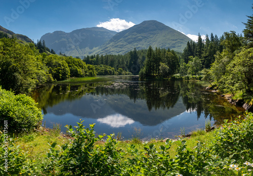 Small Scottish lake panoramic landscape,surrounded by trees at Glencoe,Scotland,United Kingdom. © Neil