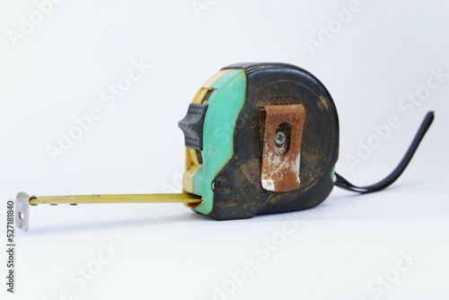 a used black, yellow, and green measuring tape isolated on white background, dirty measuring tape