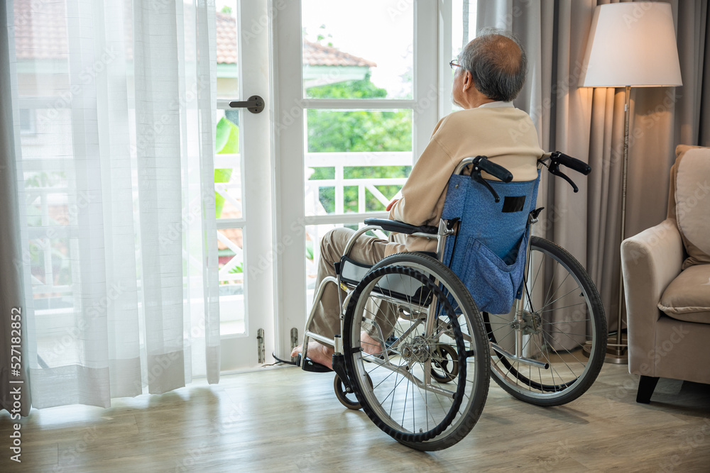Asian senior man disabled sitting alone in wheelchair looking through window at hospital, lonely elder thoughtful sad old man look outside windows in bedroom at retirement home, feel depressed lonely Asian senior man disabled sitting alone in wheelchair looking through window at hospital, lonely elder thoughtful sad old man look outside windows in bedroom at retirement home, feel depressed lonely