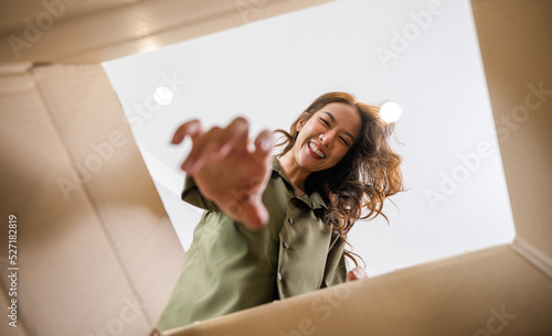 Fotografie Happy Asian young woman opening carton box from internet store order shopping on