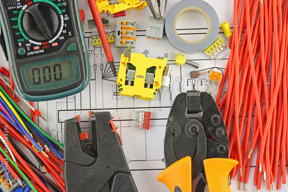 Multimeter and electrical tools in the electrical diagram close-up