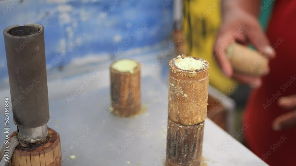 Process of making traditional indonesian food stall, kue putu bambu. From rice flour and formed using bamboo molds. the whistle sound of cooking and pandan aroma is very si Process of making traditional indonesian food stall, kue putu bambu. From rice flour and formed using bamboo molds. the whistle sound of cooking and pandan aroma is very si