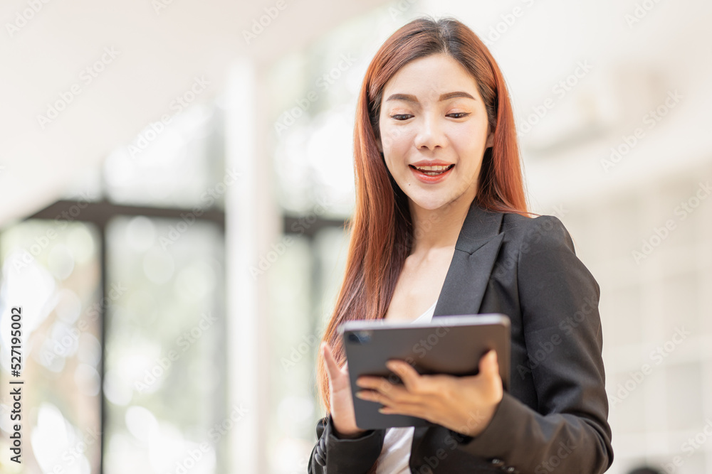 Business Asian Female holding tablet laptop and steanding in the workplace, concept of business accounting documents planning finance analysis and report, Business Asian Female holding tablet laptop and steanding in the workplace, concept of business accounting documents planning finance analysis and report,