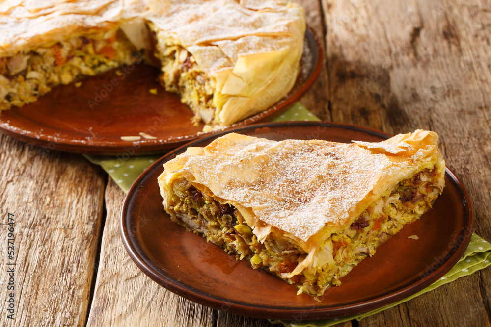 Piece Chicken Bastilla pastilla Moroccan pie closeup in the plate on the table. Horizontal